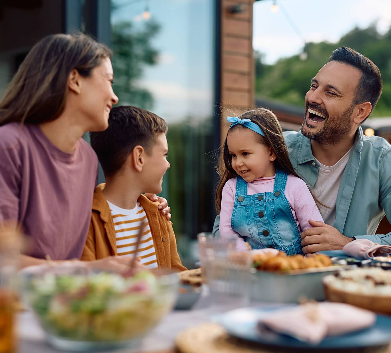 Family enjoying a meal together on their outdoor deck